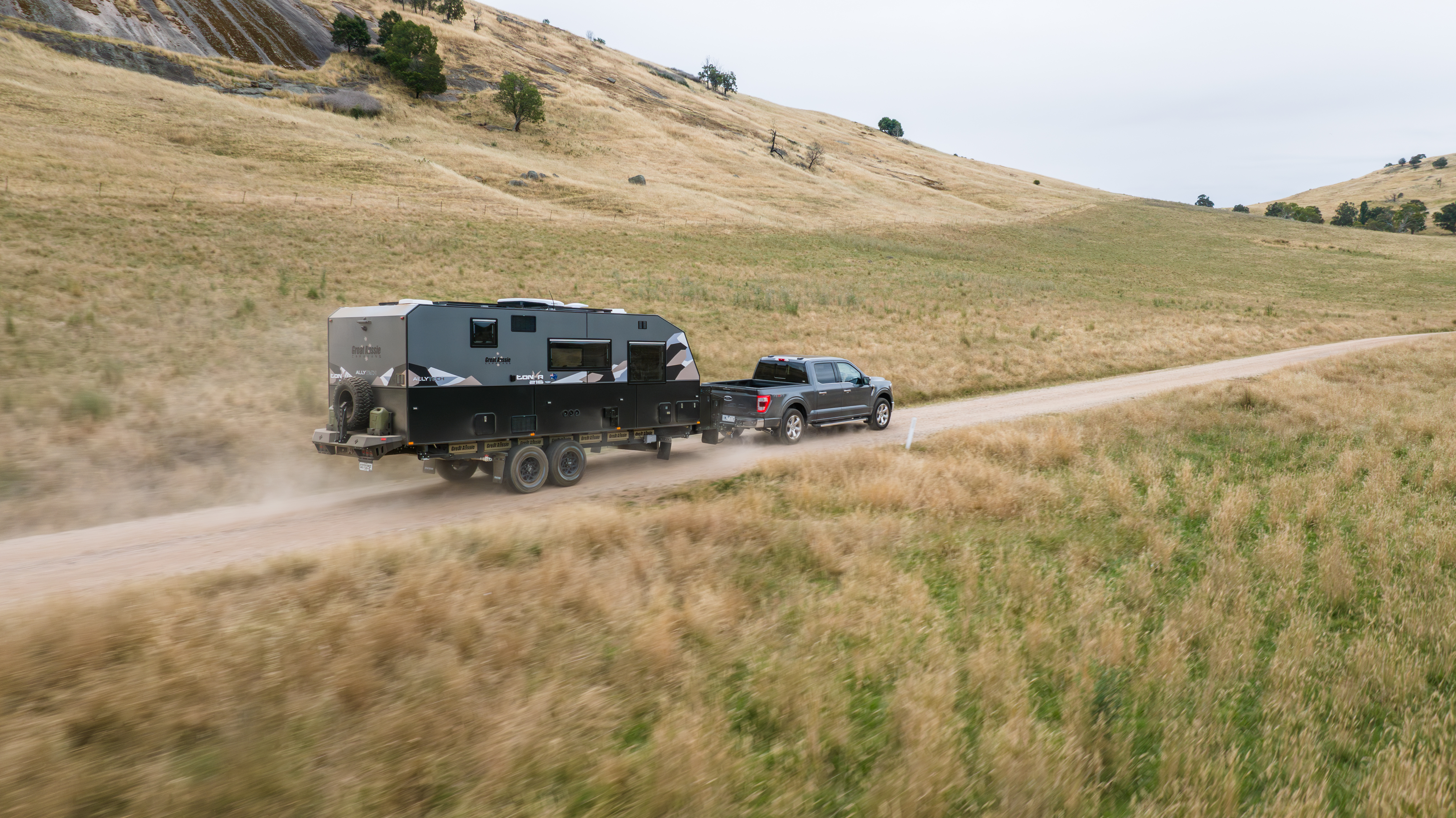 Great Aussie caravan towed through golden hills