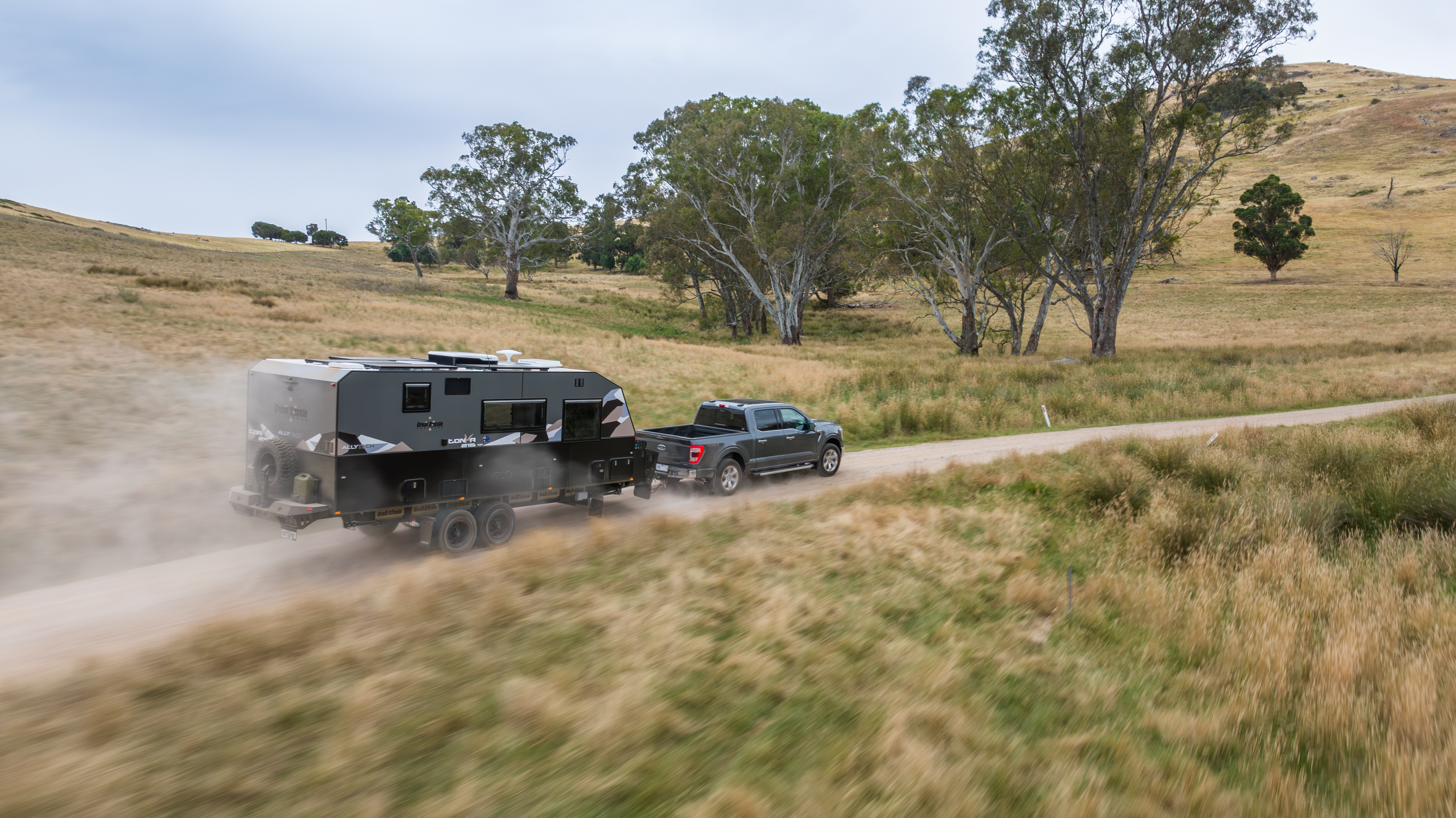 Great Aussie caravan on a dirt road through Australian countryside